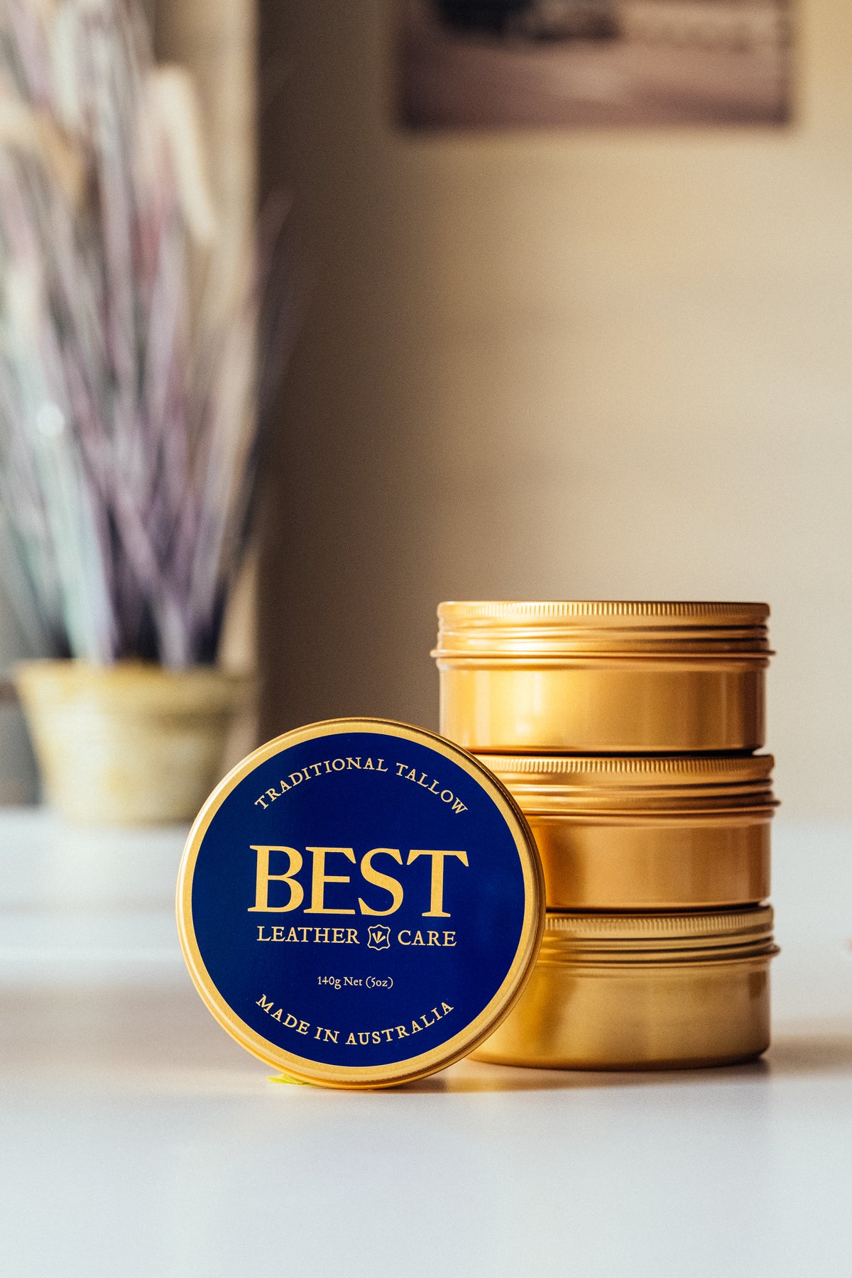 BEST Leather Care 140g tin with gold tins stacked behind